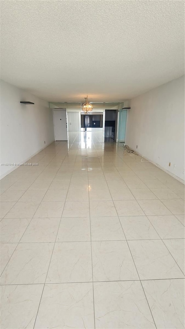 2101 S Ocean Dr Unit 2603, Hollywood, FL 33019 - empty room with a textured ceiling and light tile patterned floors