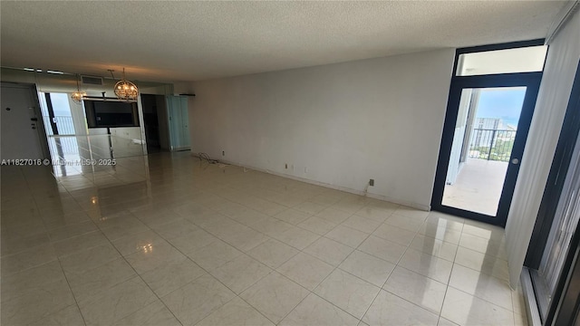 2101 S Ocean Dr Unit 2603, Hollywood, FL 33019 - spare room with healthy amount of natural light, a textured ceiling, light tile patterned flooring, and a chandelier