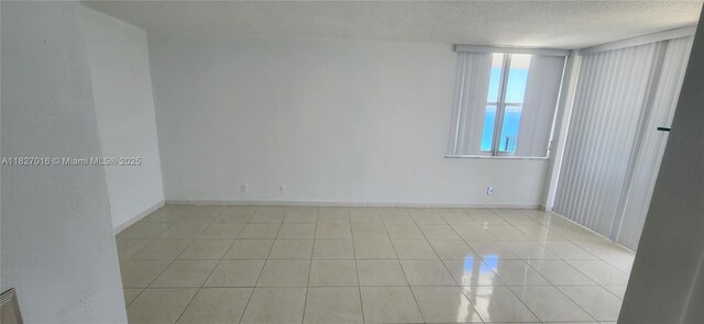 2101 S Ocean Dr Unit 2603, Hollywood, FL 33019 - spare room featuring a textured ceiling and light tile patterned flooring