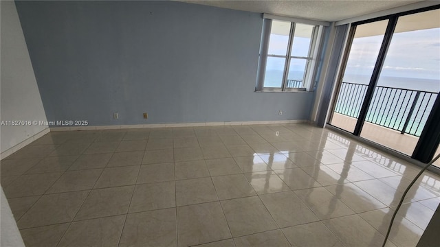 2101 S Ocean Dr Unit 2603, Hollywood, FL 33019 - unfurnished room featuring a water view, tile patterned floors, and a textured ceiling