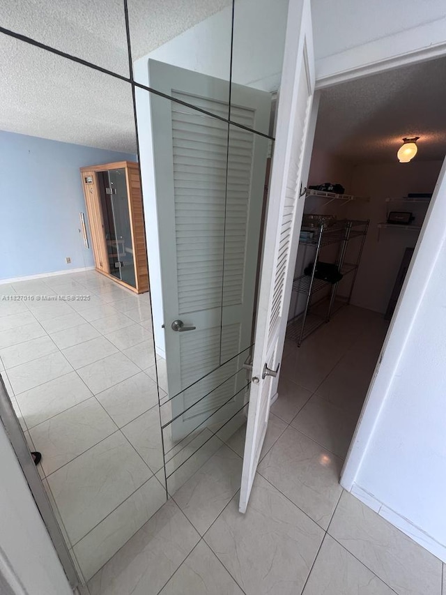 2101 S Ocean Dr Unit 2603, Hollywood, FL 33019 - bathroom with a textured ceiling, a walk in closet, and tile patterned floors