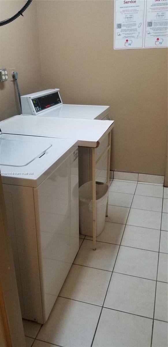 2101 S Ocean Dr Unit 2603, Hollywood, FL 33019 - communal laundry room with light tile patterned flooring and washing machine and dryer