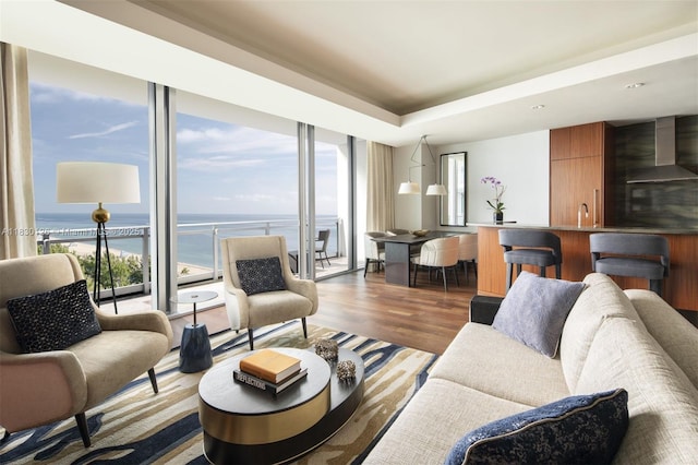 10295 Collins Ave Unit 1114, Bal Harbour, FL 33154 - living room with wood finished floors, a water view, expansive windows, and a raised ceiling