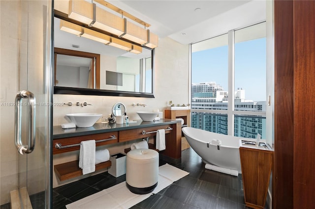 10295 Collins Ave Unit 1114, Bal Harbour, FL 33154 - bathroom featuring double vanity, a soaking tub, tile patterned flooring, backsplash, and a stall shower