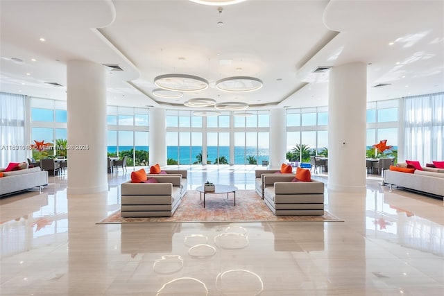 19111 Collins Ave Unit 801, Sunny Isles Beach, FL 33160 - common area with expansive windows, a towering ceiling, and a water view