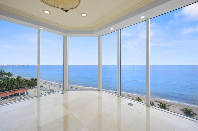 19111 Collins Ave Unit 801, Sunny Isles Beach, FL 33160 - unfurnished sunroom with tile patterned flooring, view of water and beach, a wall of windows, ornamental molding, and recessed lighting