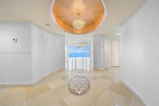 19111 Collins Ave Unit 801, Sunny Isles Beach, FL 33160 - hall featuring a raised ceiling, a chandelier, light tile patterned floors, and recessed lighting