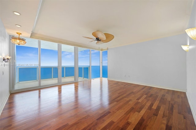 19111 Collins Ave Unit 801, Sunny Isles Beach, FL 33160 - empty room with a water view, a chandelier, wood finished floors, a ceiling fan, and recessed lighting