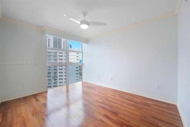 19111 Collins Ave Unit 801, Sunny Isles Beach, FL 33160 - empty room featuring crown molding, wood finished floors, a ceiling fan, and a view of city
