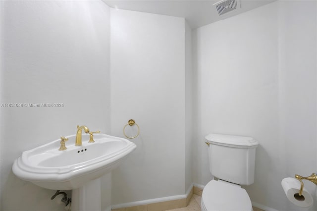 19111 Collins Ave Unit 801, Sunny Isles Beach, FL 33160 - half bathroom featuring toilet and tile patterned floors