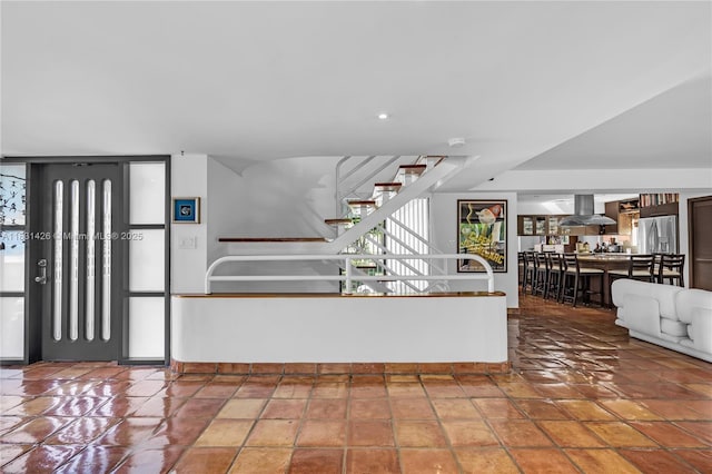 3520 Rockerman Rd, Miami, FL 33133 - kitchen featuring island exhaust hood and stainless steel fridge with ice dispenser