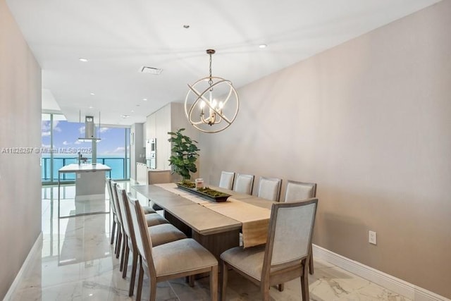 15701 Collins Ave Unit 2902, Sunny Isles Beach, FL 33160 - dining area with light marble finish floors, a chandelier, and expansive windows