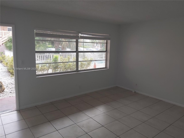 241 SE 9th Ave Unit 103, Pompano Beach, FL 33060 - empty room featuring light tile patterned flooring and baseboards