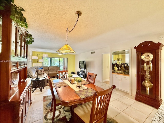 318 Lakeview Dr Unit 203, Weston, FL 33326 - dining room with light tile patterned floors and a textured ceiling