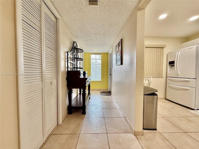 318 Lakeview Dr Unit 203, Weston, FL 33326 - corridor featuring light tile patterned flooring, a textured ceiling, and recessed lighting
