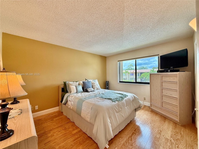 318 Lakeview Dr Unit 203, Weston, FL 33326 - bedroom with light wood finished floors and a textured ceiling