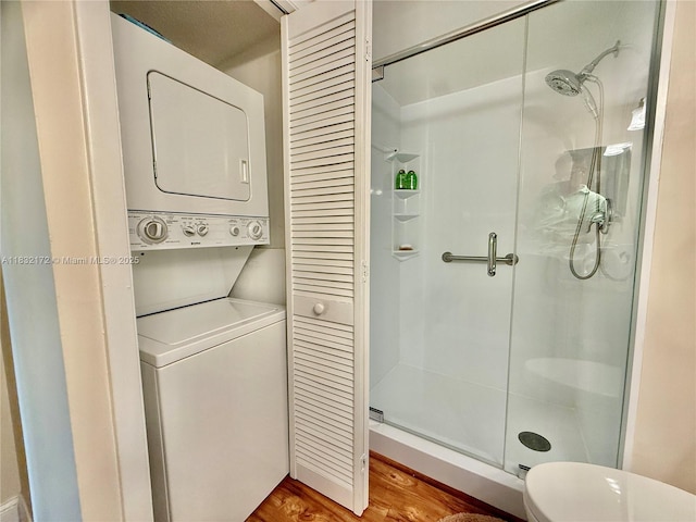 318 Lakeview Dr Unit 203, Weston, FL 33326 - bathroom featuring stacked washing machine and dryer, a stall shower, wood finished floors, and a closet