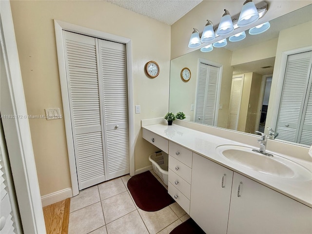 318 Lakeview Dr Unit 203, Weston, FL 33326 - bathroom featuring a closet, vanity, tile patterned flooring, and a textured ceiling