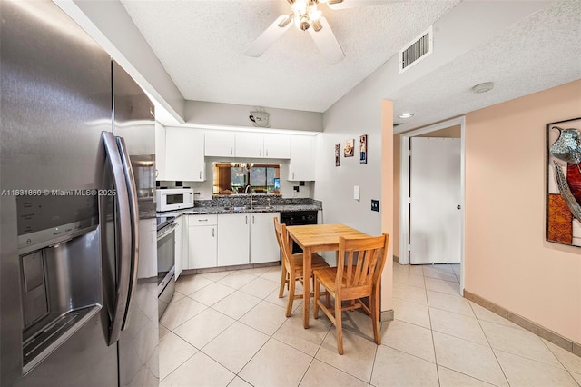 1601 SW 128th Ter Unit 209A, Pembroke Pines, FL 33027 - kitchen featuring stainless steel appliances, a textured ceiling, dark countertops, ceiling fan, and white cabinetry