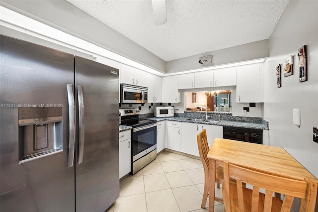 1601 SW 128th Ter Unit 209A, Pembroke Pines, FL 33027 - kitchen featuring stainless steel appliances, white cabinetry, a textured ceiling, light tile patterned floors, and backsplash