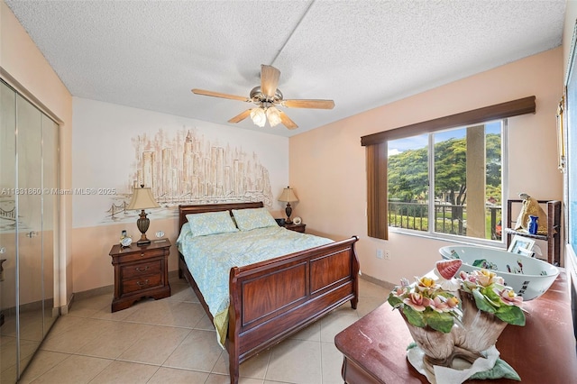 1601 SW 128th Ter Unit 209A, Pembroke Pines, FL 33027 - bedroom featuring a textured ceiling, light tile patterned floors, a closet, and ceiling fan