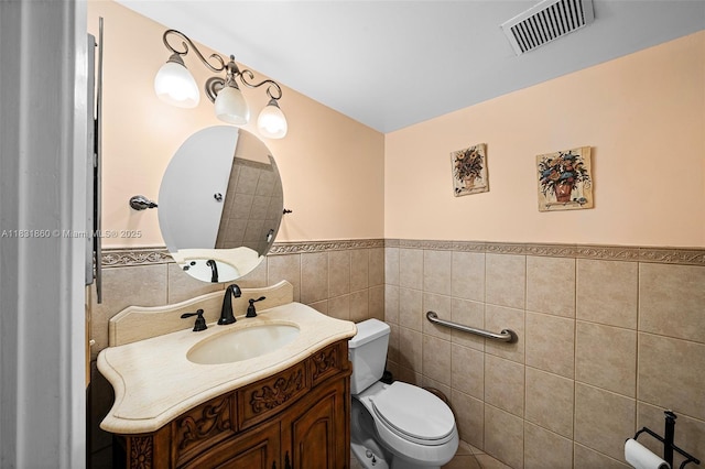 1601 SW 128th Ter Unit 209A, Pembroke Pines, FL 33027 - bathroom featuring tile walls, a wainscoted wall, and vanity