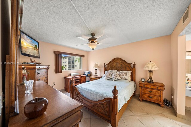 1601 SW 128th Ter Unit 209A, Pembroke Pines, FL 33027 - bedroom featuring light tile patterned floors, a textured ceiling, and ceiling fan