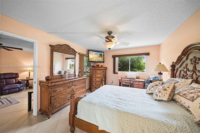 1601 SW 128th Ter Unit 209A, Pembroke Pines, FL 33027 - bedroom with a textured ceiling, a ceiling fan, and light tile patterned floors