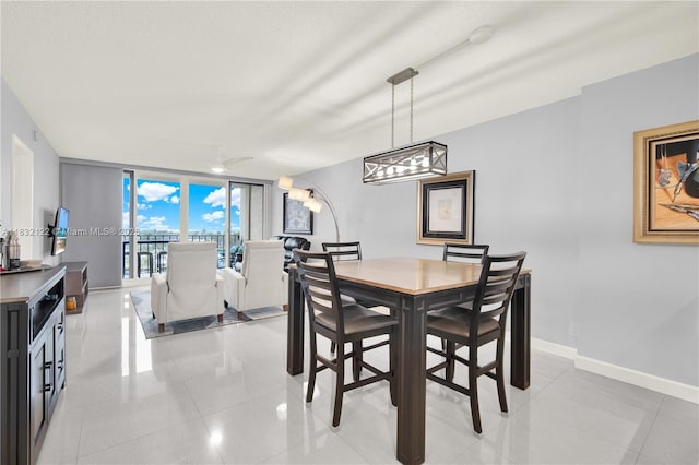 521 N Riverside Dr Unit 707, Pompano Beach, FL 33062 - dining room featuring light tile patterned floors, expansive windows, and a chandelier