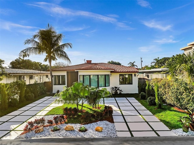 9448 Abbott Ave, Surfside, FL 33154 - view of front facade with a tiled roof and stucco siding