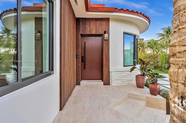 9448 Abbott Ave, Surfside, FL 33154 - property entrance with elevator, a tile roof, and stucco siding