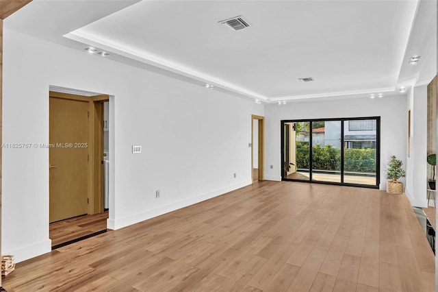 9448 Abbott Ave, Surfside, FL 33154 - empty room with a raised ceiling and light wood-style flooring