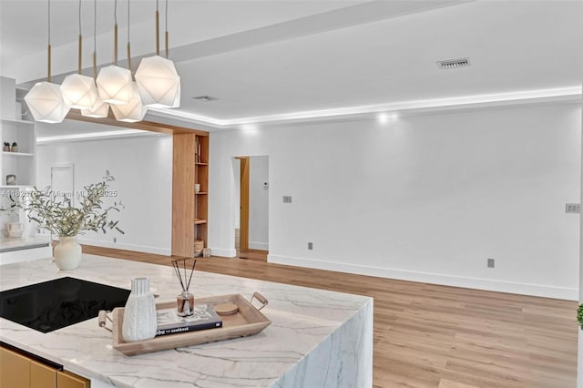 9448 Abbott Ave, Surfside, FL 33154 - kitchen with light wood-style flooring, decorative light fixtures, and light stone counters