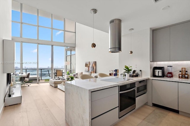 1100 Biscayne Blvd Unit 4305, Miami, FL 33132 - kitchen with oven, a peninsula, a water view, modern cabinets, and light wood-style flooring
