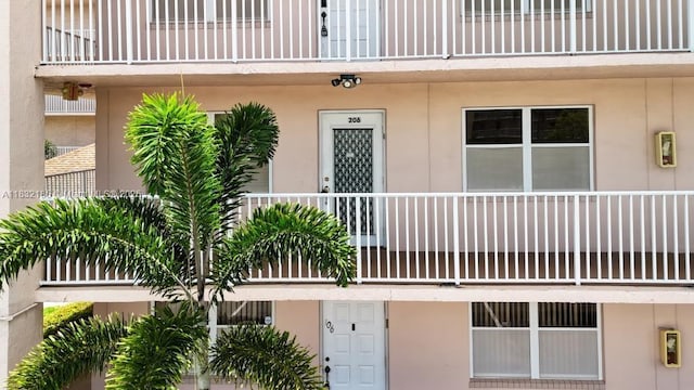 2607 NW 104th Ave Unit 206, Sunrise, FL 33322 - view of exterior entry with a balcony and stucco siding