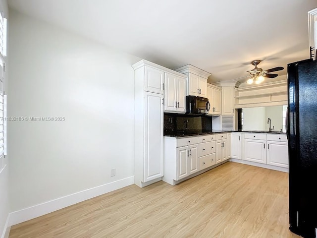 2607 NW 104th Ave Unit 206, Sunrise, FL 33322 - kitchen featuring black appliances, light wood-style flooring, ceiling fan, and dark countertops