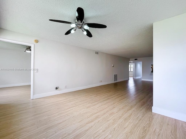 2607 NW 104th Ave Unit 206, Sunrise, FL 33322 - unfurnished living room with a textured ceiling, light wood-style floors, and a ceiling fan