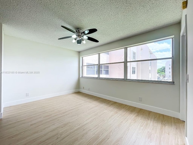 2607 NW 104th Ave Unit 206, Sunrise, FL 33322 - spare room with a textured ceiling, wood finished floors, and a ceiling fan