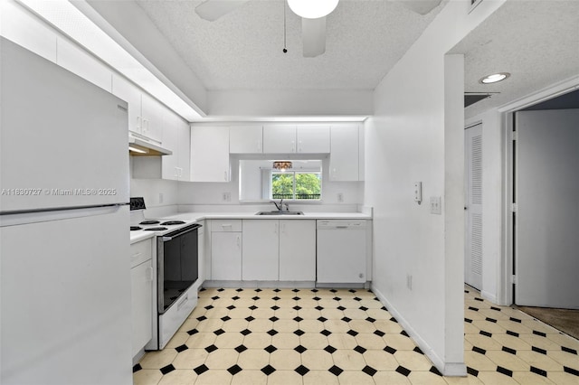 13701 SW 12th St Unit 405A, Pembroke Pines, FL 33027 - kitchen with white appliances, a textured ceiling, light floors, light countertops, and under cabinet range hood