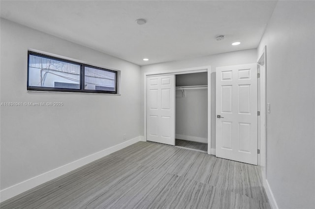 212 SW 11th Ave, Dania Beach, FL 33004 - unfurnished bedroom featuring wood finished floors, a closet, and recessed lighting