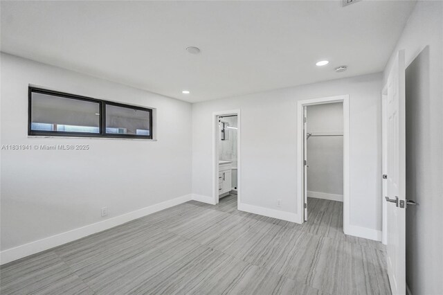 212 SW 11th Ave, Dania Beach, FL 33004 - unfurnished bedroom with a walk in closet, recessed lighting, a closet, and ensuite bathroom