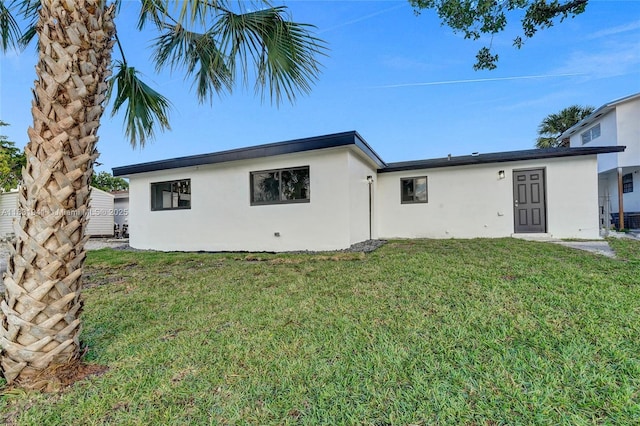 212 SW 11th Ave, Dania Beach, FL 33004 - back of property featuring stucco siding and a yard