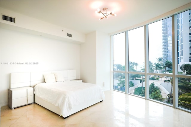 18101 Collins Ave Unit 701, Sunny Isles Beach, FL 33160 - bedroom featuring light tile patterned flooring and a wall of windows