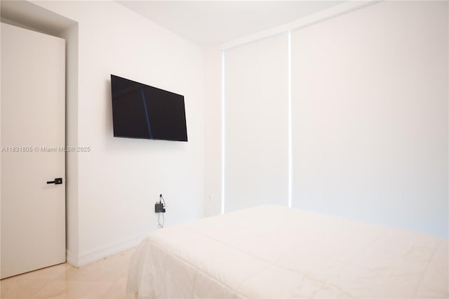 18101 Collins Ave Unit 701, Sunny Isles Beach, FL 33160 - bedroom featuring baseboards and light tile patterned floors