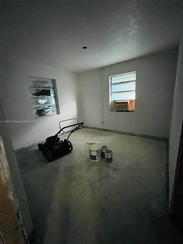 1344 W 10th St, Riviera Beach, FL 33404 - empty room with cooling unit and unfinished concrete flooring