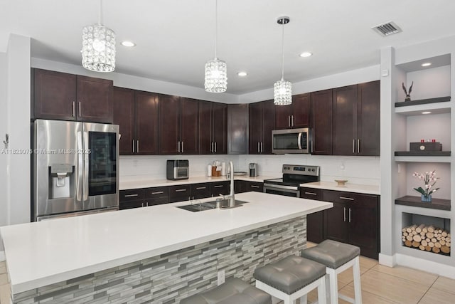 18350 SW 139th Path, Miami, FL 33177 - kitchen featuring stainless steel appliances, light countertops, a chandelier, hanging light fixtures, and recessed lighting