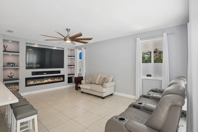 18350 SW 139th Path, Miami, FL 33177 - living area featuring light tile patterned flooring, ceiling fan, a glass covered fireplace, and built in features