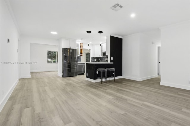 524 NW 7th Ct, Boynton Beach, FL 33426 - living area featuring light wood-style floors, ornamental molding, and recessed lighting