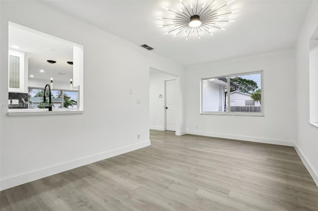 524 NW 7th Ct, Boynton Beach, FL 33426 - unfurnished room featuring wood finished floors and a chandelier