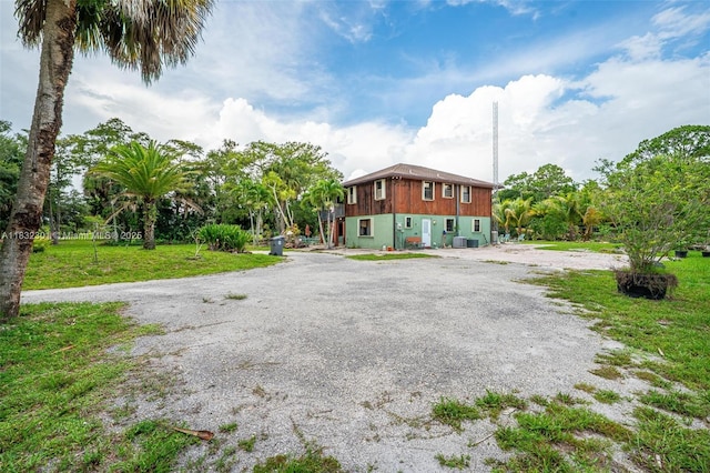 576 Marshall Rd, West Palm Beach, FL 33413 - view of side of home with a yard and driveway